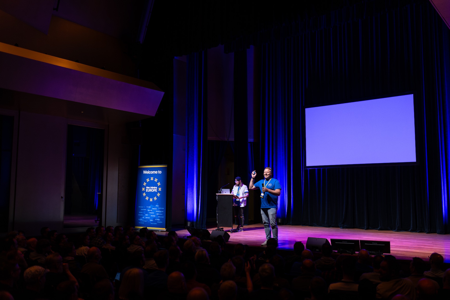 A speaker on stage at Mac Admins Europe 2026 in Leiden