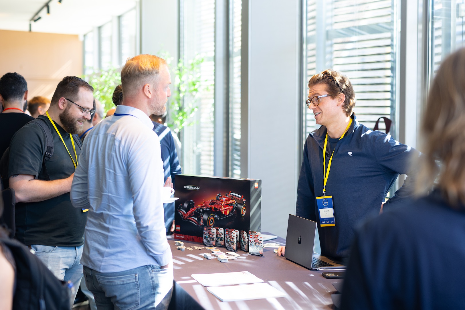 Attendees talking at an exhibitor table at Mac Admins Europe 2026